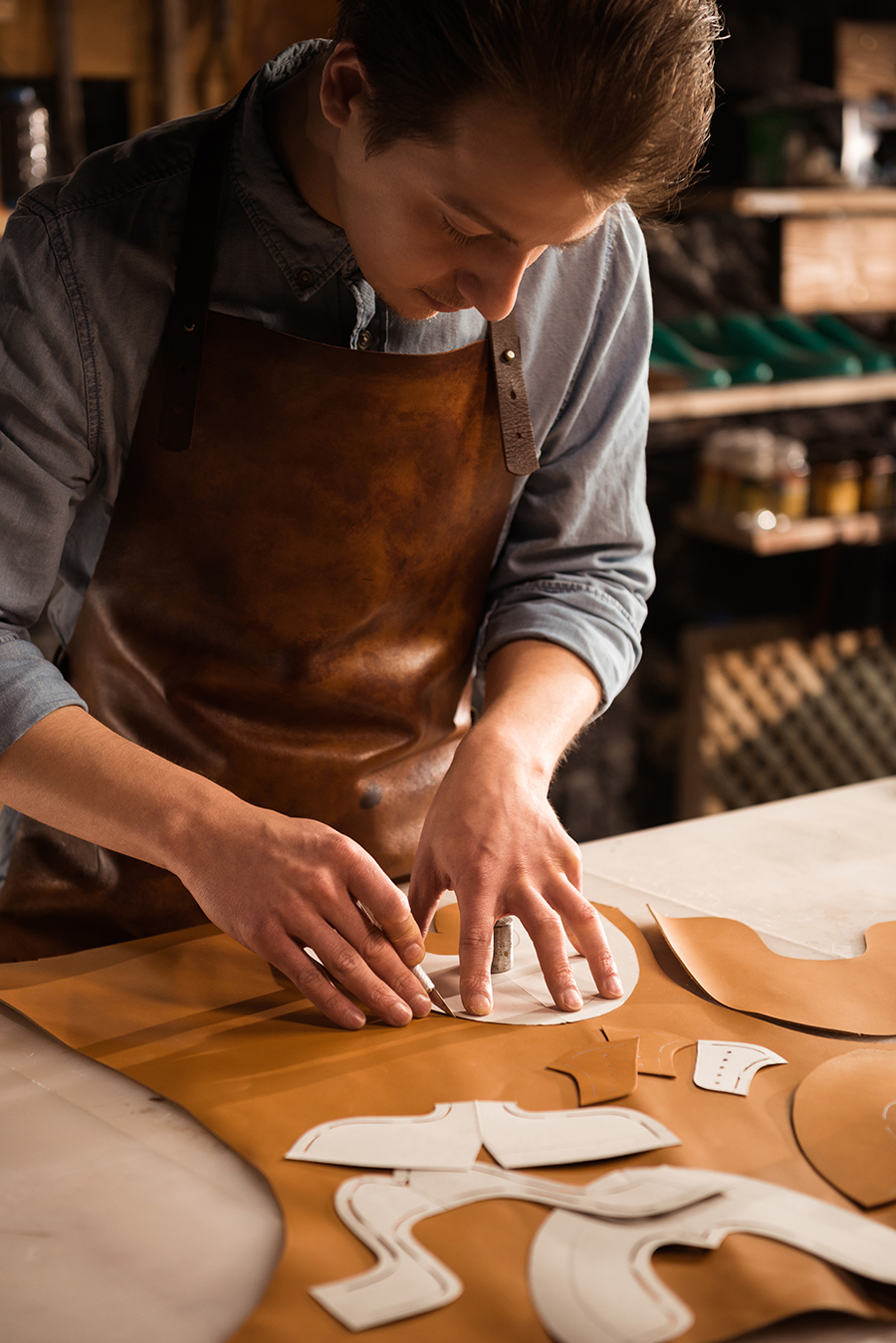 close-up-male-cobbler-working-with-leather-textile